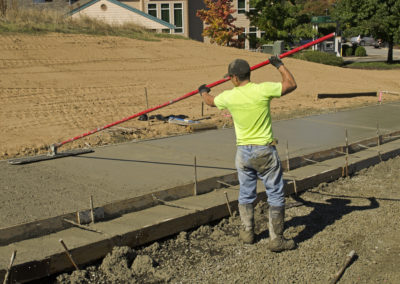 A worker is resurfacing a concrete driveway in Los Angeles